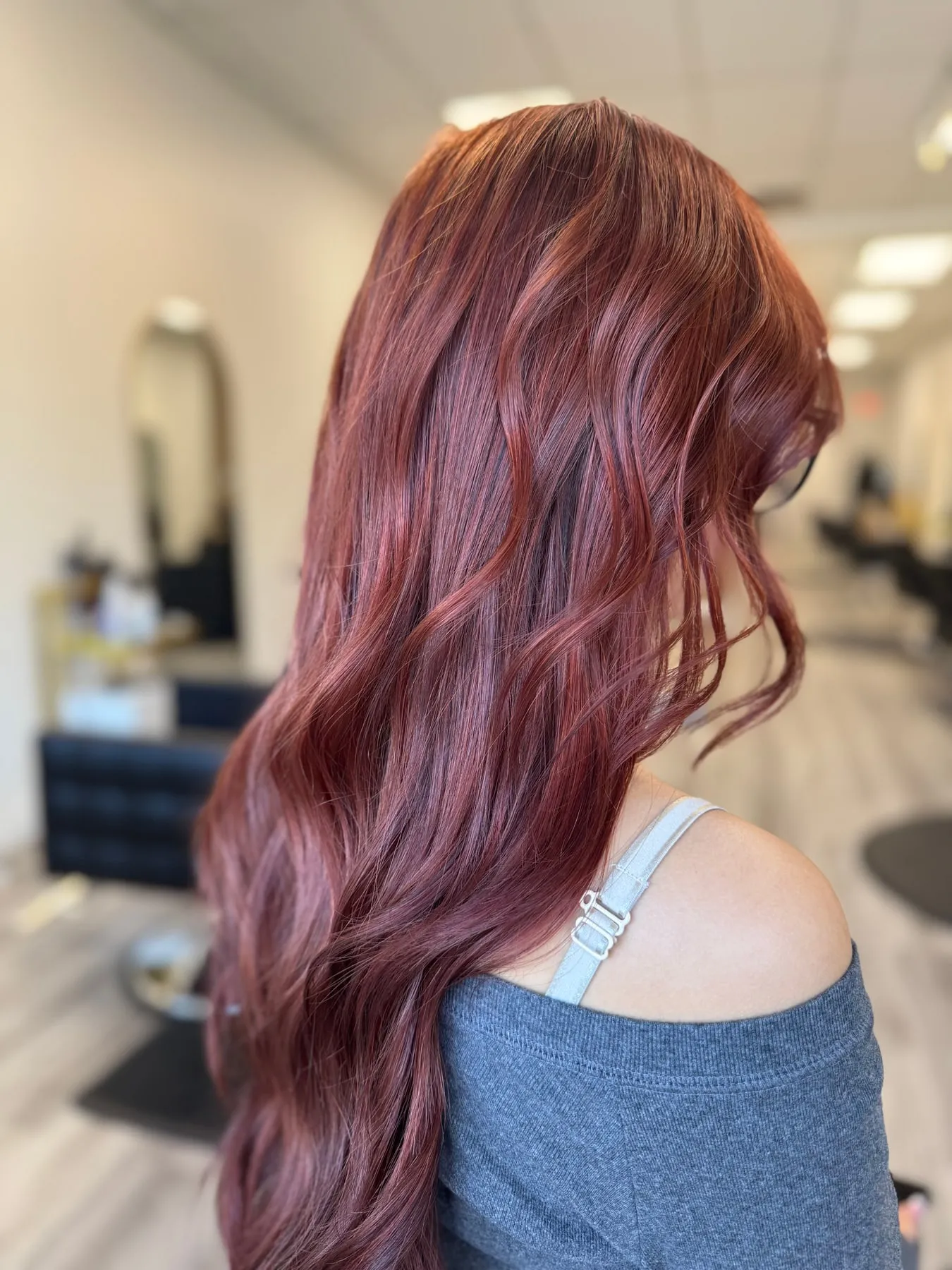 Rich salon hair colour with glossy finish on mid-length hair, professional colour service at Emilie Hair Studio, Vancouver.